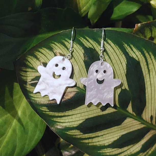 Happy ghost earrings on a monstera leaf
